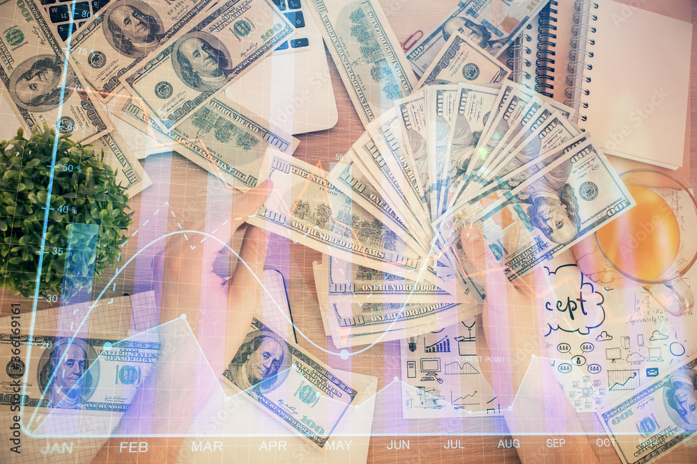 Multi exposure of financial graph drawing hologram and USA dollars bills and man hands. Analysis concept. Multi exposure of financial graph drawing hologram and USA dollars bills and man hands. Analysis concept.