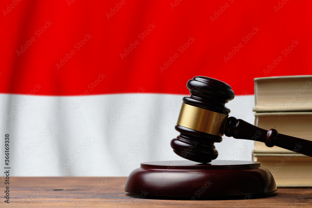 Justice and court concept in Republic of Indonesia. Judge hammer on a flag background