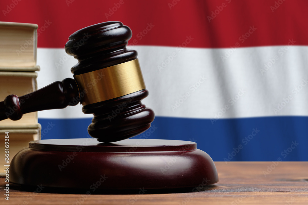 Justice and court concept in Netherlands. Judge hammer on a flag background