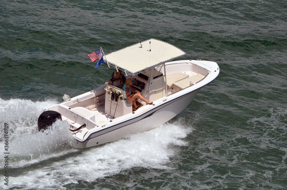Fototapeta premium Angled overhead view of an open sport fishing boat with canvas covered canopy center console.