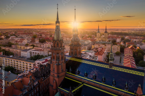 Aerial drone view of the Cathedral of St. Peter and Paul the Apostles and old town buildings before sunset. The sun's rays beautifully highlight the urban architecture in Legnica, Poland