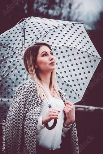 Woman thinking under an umbrella