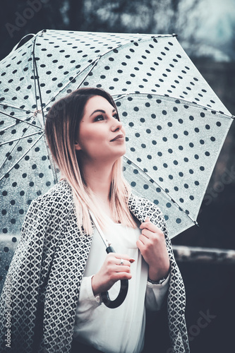Woman thinking under an umbrella