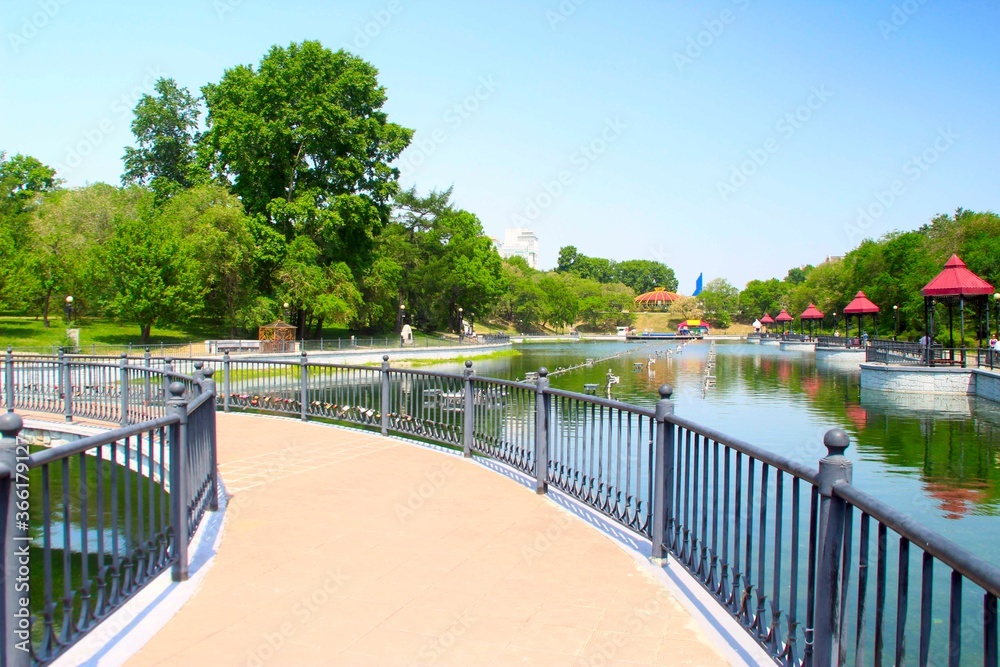 bridge over the lakes in the city park Khabarovsk Russia summer