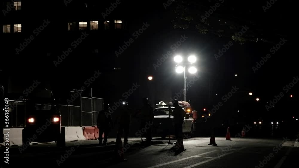 Workers repairing a street at night