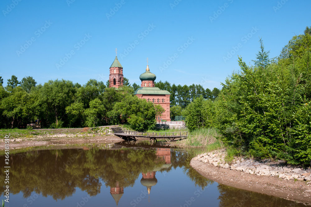 Russian village, summer landscape lake and old Orthodox Church