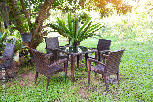 Table and chairs in the garden under the tree summer - Set of table chair outdoor nature green background