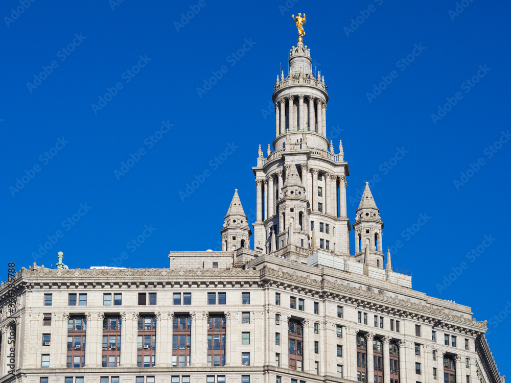 tall white building with a bright blue sky behind