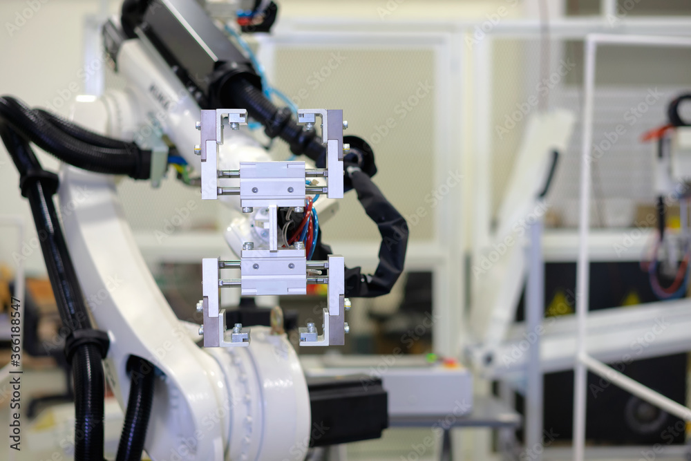 Factory 4.0 concept: View of gripper unit on handerling robot arm of automation machine. Factory 4.0 concept: View of gripper unit on handerling robot arm of automation machine.