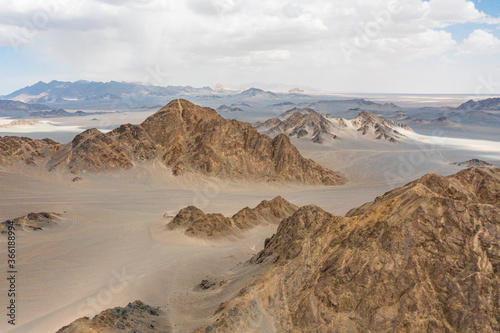 aerial view of sand moutain in desert with blue sky