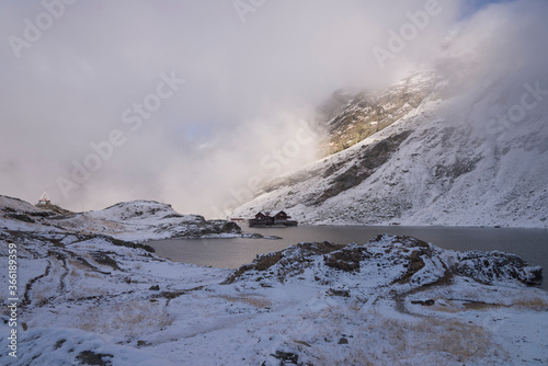 Balea Lake surrounded by snowy mountains in late autumn