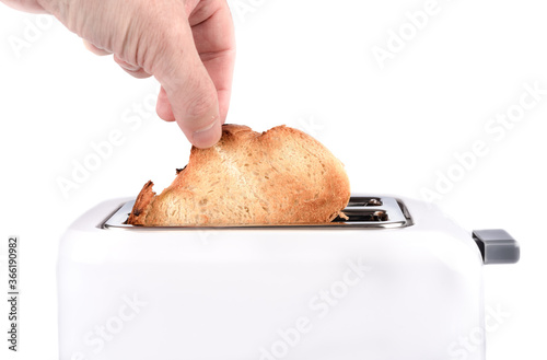 Human hand takes out toasted bread toast from a toaster.