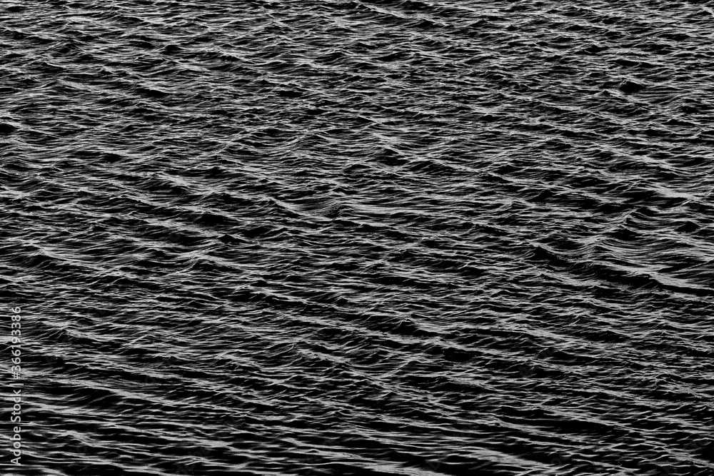 An abstract image in monochrome of ripples on water creating a pattern which can be used for background or tiles or writing a message An abstract image in monochrome of ripples on water creating a pattern which can be used for background or tiles or writing a message