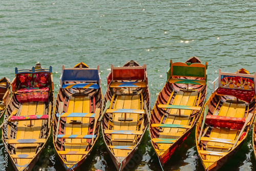 Boats floating on water in a lake in  hill station Bhimtal in Nainital district of India a famous tourist destination photo