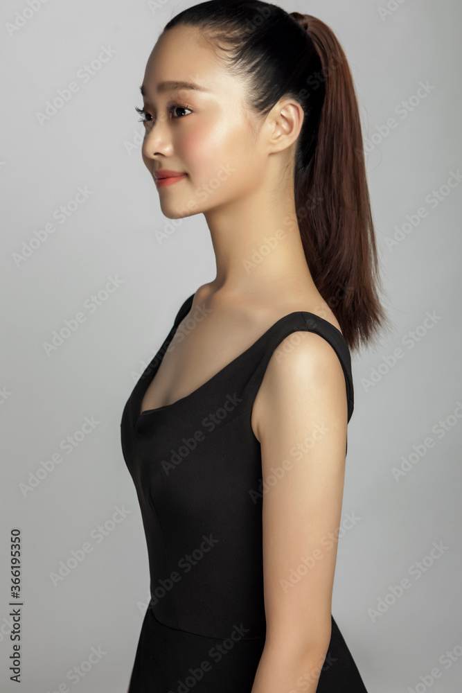 Fototapeta premium Asian young woman wearing black dress