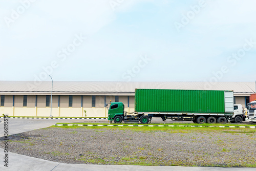 Trucks parked in front of the warehouse building © Leo Lintang