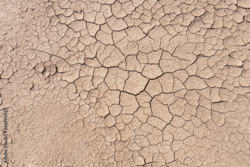 Dry soil ground cracks background texture in drought, Top view Dry soil ground cracks background texture in drought, Top view