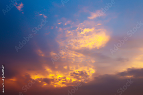 Dramatic atmosphere panorama view of natural sunlight effect on blurry soft clouds with twilight golden sunset sky for silhouette background.