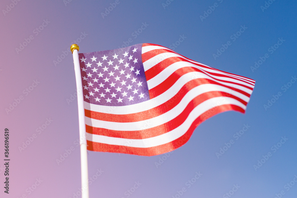 Fototapeta premium USA flag waving in blue sky. American flag mockup with the space for your content. Design