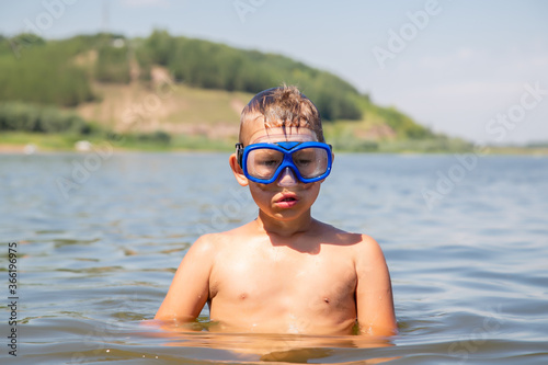 portrait of a boy in a diving mask standing in the water © vitec40
