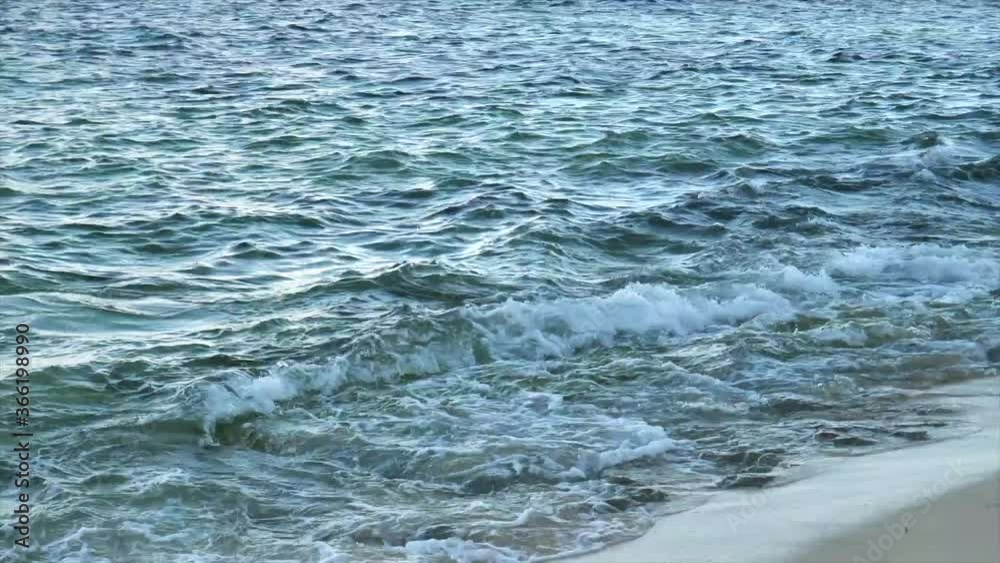 Sea Waves Splashing On The Sandy Shore At The Beach - close up Sea Waves Splashing On The Sandy Shore At The Beach - close up
