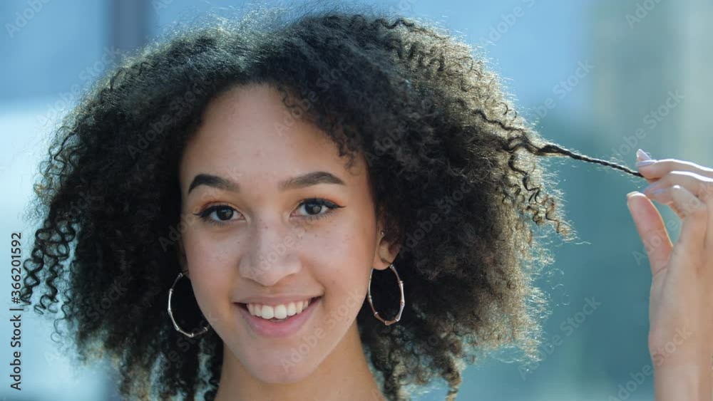 Closeup face african girl curly hairstyle. Young American playful