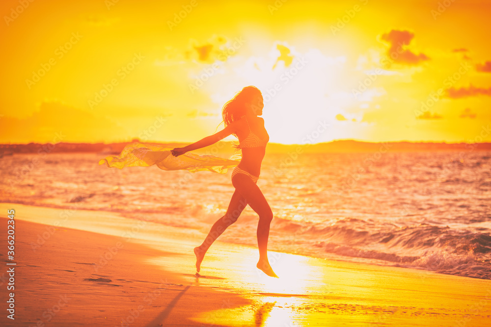 Happy free sexy woman silhouette running with scarf flying in the wind at sunset glow for weight loss happiness concept. Sun vacation travel beach. Happy free sexy woman silhouette running with scarf flying in the wind at sunset glow for weight loss happiness concept. Sun vacation travel beach.