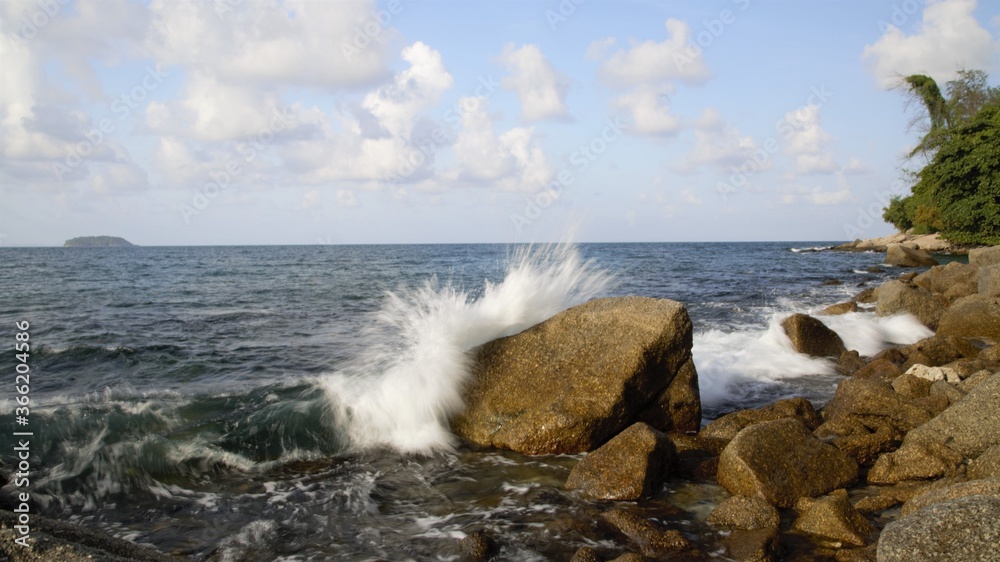 waves breaking on the rocks Kratin Beach Phuket Thailand