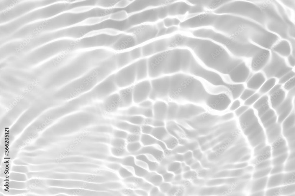 Closeup of desaturated transparent clear calm water surface texture with splashes and bubbles. Trendy abstract nature background. White-grey water waves in sunlight. Closeup of desaturated transparent clear calm water surface texture with splashes and bubbles. Trendy abstract nature background. White-grey water waves in sunlight.