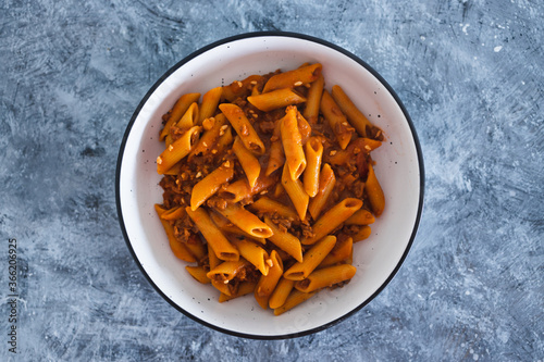 plant-based food, vegan penne pasta with red pesto and bean bolognaise sauce