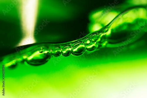 Soap bubbles on a rich green neon background.The shape and texture of the foam.gradient green color.macro mode.