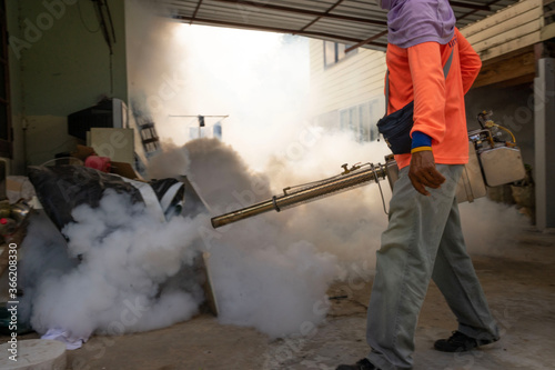 Buriram, Thailand, 14 July 2020, men spraying haze to prevent the spread of dengue fever in Thailand.