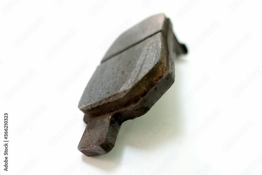Worn out brake pad or brake shoes, component showing steel backing plates with friction material bound to the surface that faces the disc brake rotor - vehicle safety concept Worn out brake pad or brake shoes, component showing steel backing plates with friction material bound to the surface that faces the disc brake rotor - vehicle safety concept