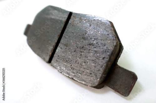 Worn out brake pad or brake shoes, component showing steel backing plates with friction material bound to the surface that faces the disc brake rotor - vehicle safety concept