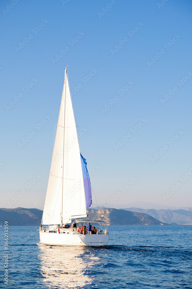 Racing yacht in the sea on blue sky background. Peaceful seascape. Travel concept, travelling.
