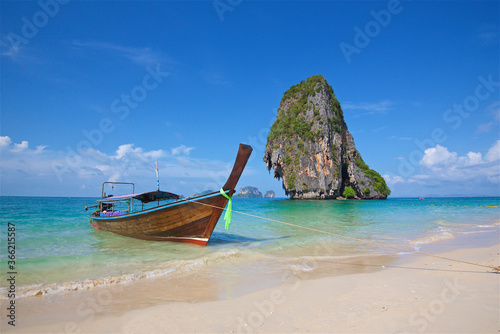 Thai fishing boats on Phi Phi island in the andaman sea in Thailand, clear turquoise water, scenic island, heavenly delight, postcard background