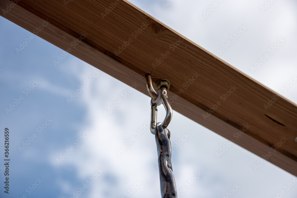 Fototapeta premium Eye-loop screw mount on bottom of wooden beam