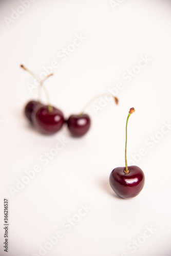 cherry in the foreground against the background of a fish on a white background