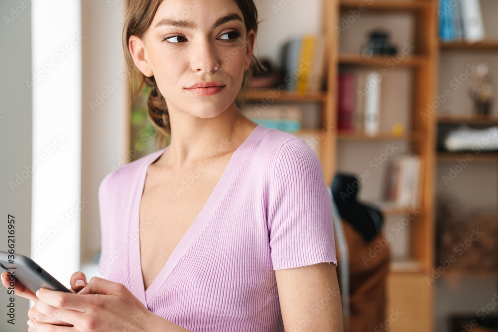 Smiling young woman designer indoors chatting Smiling young woman designer indoors chatting