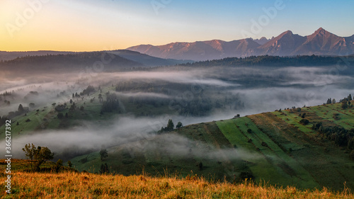 beautiful landscape with valleys, lakes and rivers in fog under High Tatras