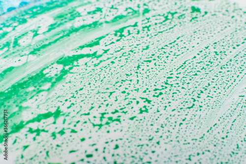 Drops of Blu Green Paint on White Plastic