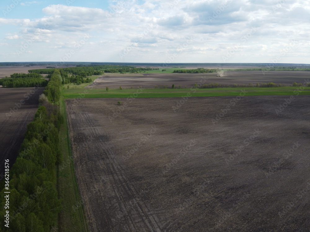 Two fields separated by a forest belt, aerial view. Agricultural landscape. Two fields separated by a forest belt, aerial view. Agricultural landscape.