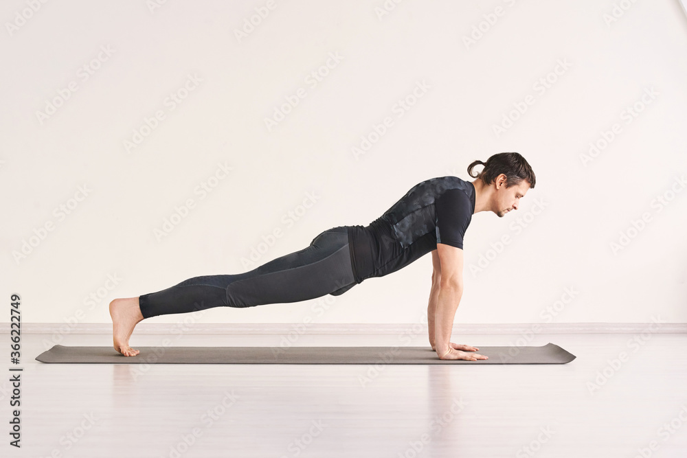 Fototapeta premium Man stand at plank. Home sport static training. Social distancing quarantine lifestyle. Health pushup. Person yoga asana. Ashtanga pose. Muscle stretching. Morning fitness effort