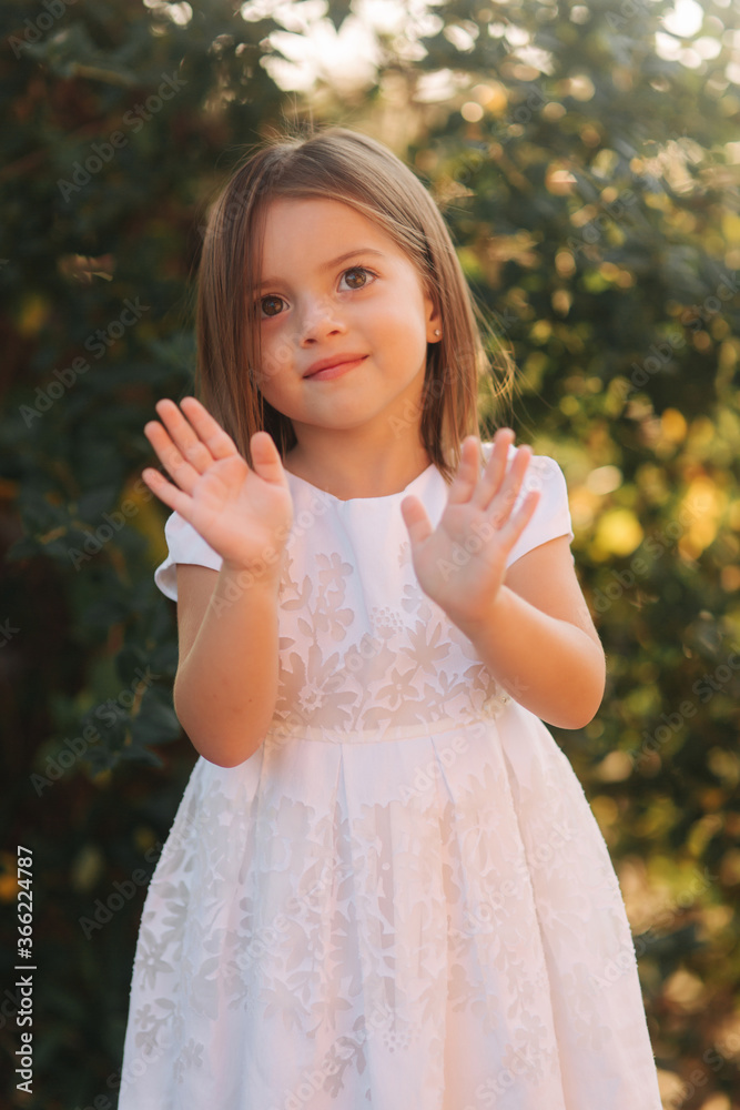 Portrait of happy smiled little girl in white dress Portrait of happy smiled little girl in white dress