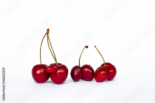 group of red fused cherries isolated on white background, ugly food concept, GMO