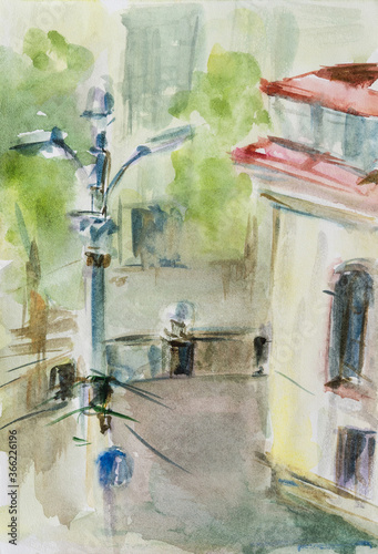 Watercolor sketch of an urban landscape. Quick sketch in the vertical format of a city street. Lamppost and corner of the building. City sketch.