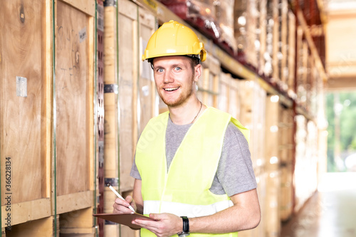Portrait white caucasian worker with tablet in distribution warehouse