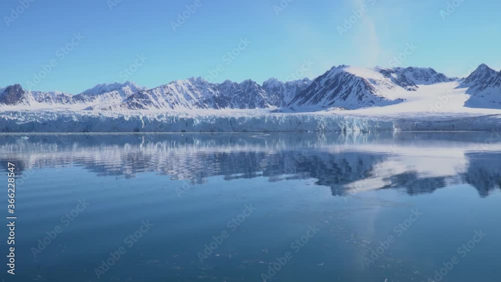 A beautiful reflection of snowy mountains in the Arctic sea, Spitsbergen Svalbard A beautiful reflection of snowy mountains in the Arctic sea, Spitsbergen Svalbard