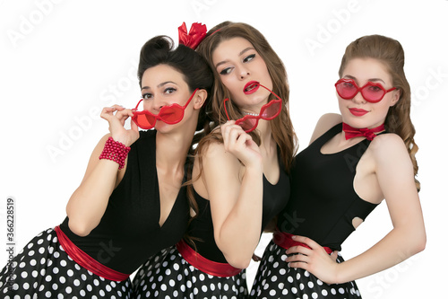 Three beautiful retro girls. A group of women in red glasses.