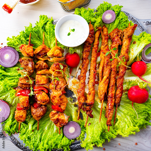 Grilled szaszlyk and meat flares with green salad photo